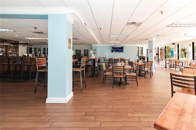 dining room featuring bar and wood-type flooring