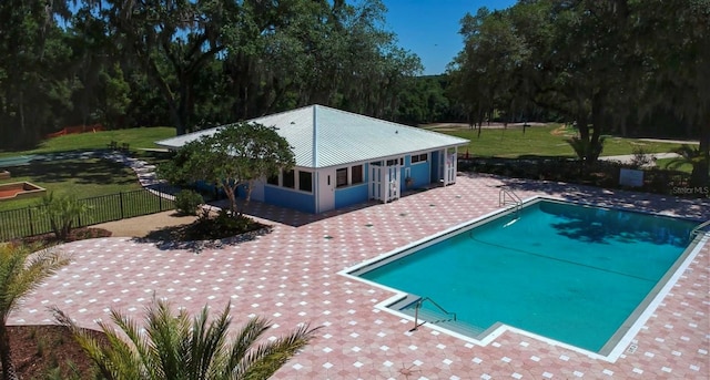 view of swimming pool with a patio area and a lawn