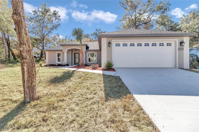 view of front of property featuring a garage and a front yard