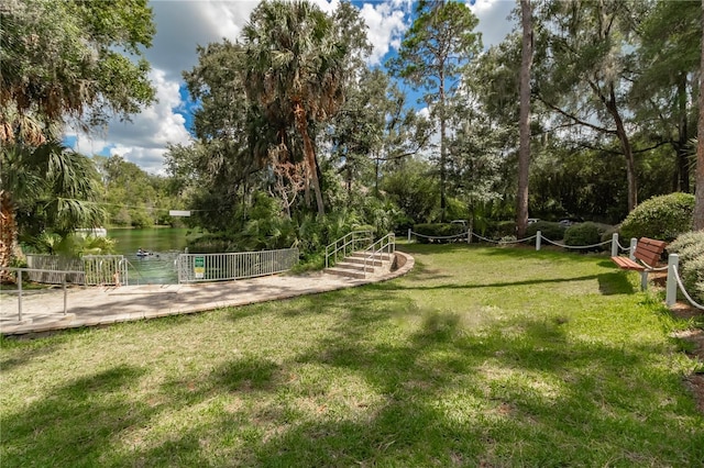 view of property's community featuring a yard and a water view