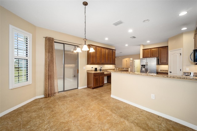 kitchen with light tile patterned flooring, plenty of natural light, and stainless steel appliances