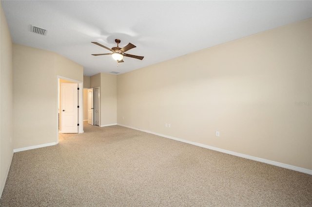 carpeted spare room with ceiling fan