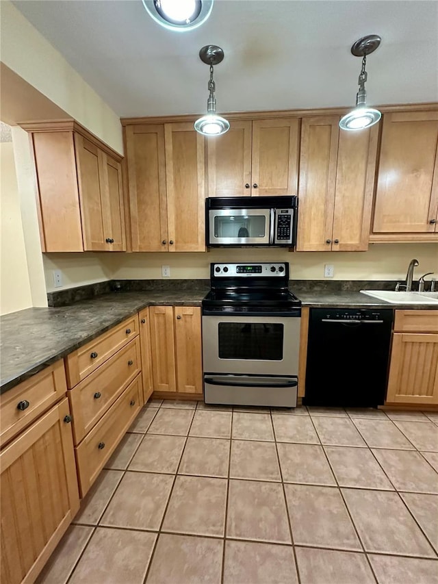 kitchen with sink, stainless steel appliances, decorative light fixtures, and light tile patterned floors