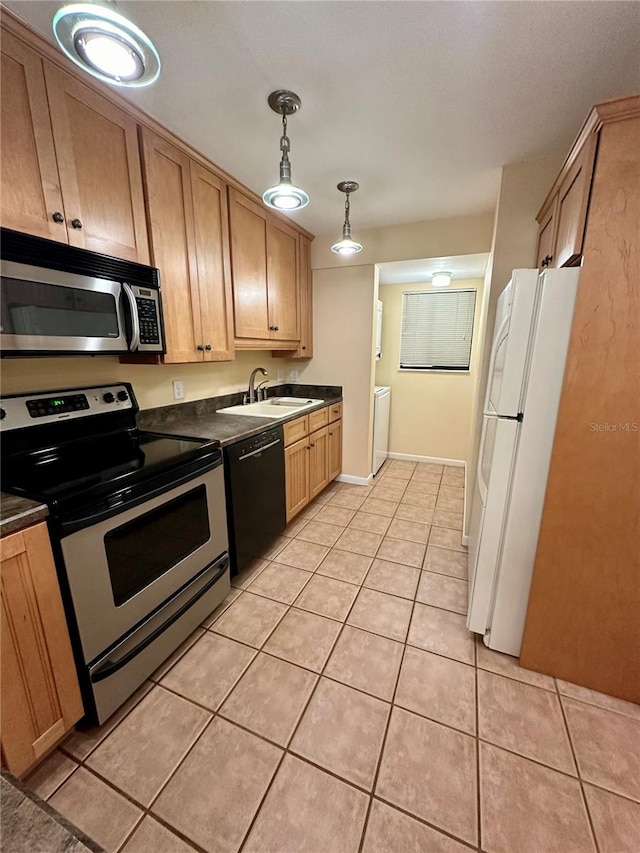 kitchen with light tile patterned floors, pendant lighting, and stainless steel appliances