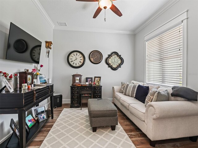 living room featuring ornamental molding, dark hardwood / wood-style flooring, a wealth of natural light, and ceiling fan