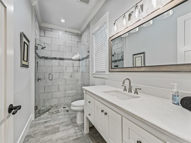 bathroom featuring vanity, a shower with shower door, crown molding, toilet, and tile patterned flooring