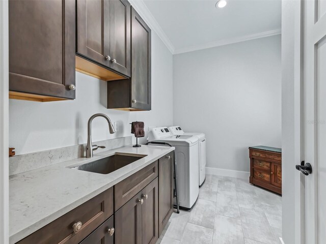 laundry area with sink, cabinets, crown molding, independent washer and dryer, and light tile patterned flooring