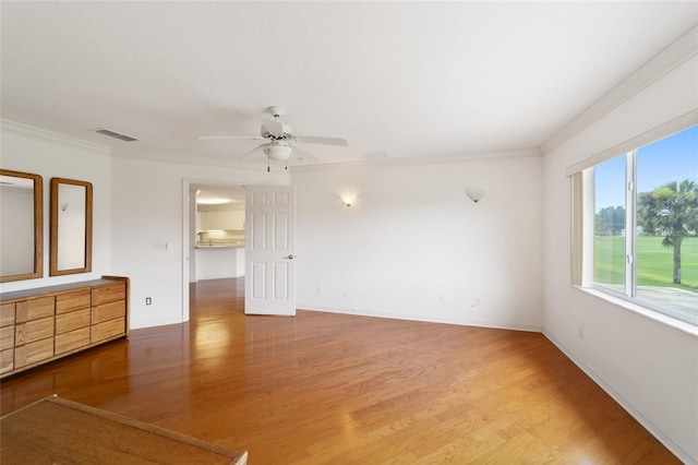 unfurnished room featuring hardwood / wood-style flooring, ornamental molding, and ceiling fan