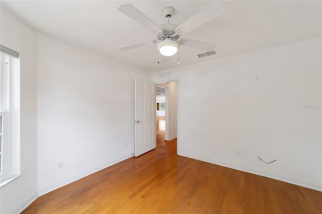 unfurnished room with hardwood / wood-style floors and ceiling fan