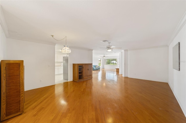 unfurnished living room featuring crown molding, ceiling fan, and hardwood / wood-style floors