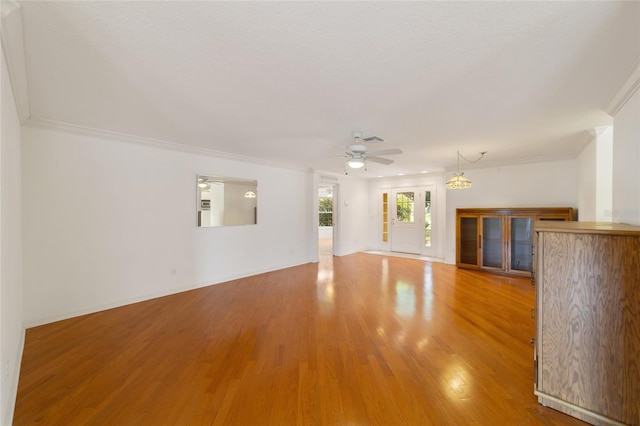 unfurnished living room with ornamental molding, hardwood / wood-style floors, a textured ceiling, and ceiling fan