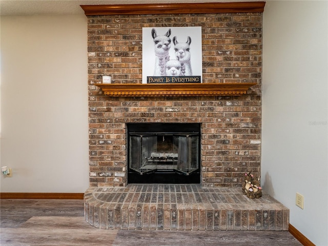 details featuring hardwood / wood-style flooring, a fireplace, and a textured ceiling