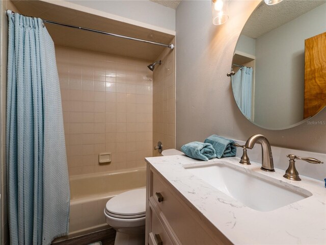 full bathroom with vanity, a textured ceiling, toilet, and shower / bath combination with curtain