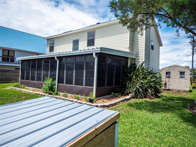 rear view of property with a sunroom and a lawn