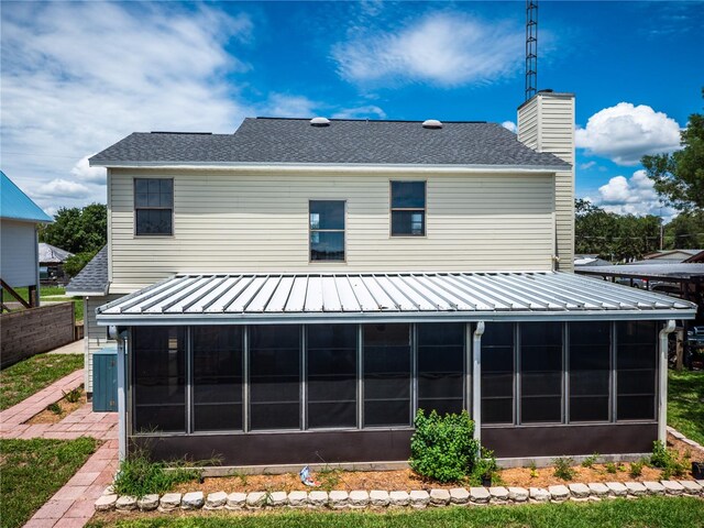 back of house featuring a sunroom