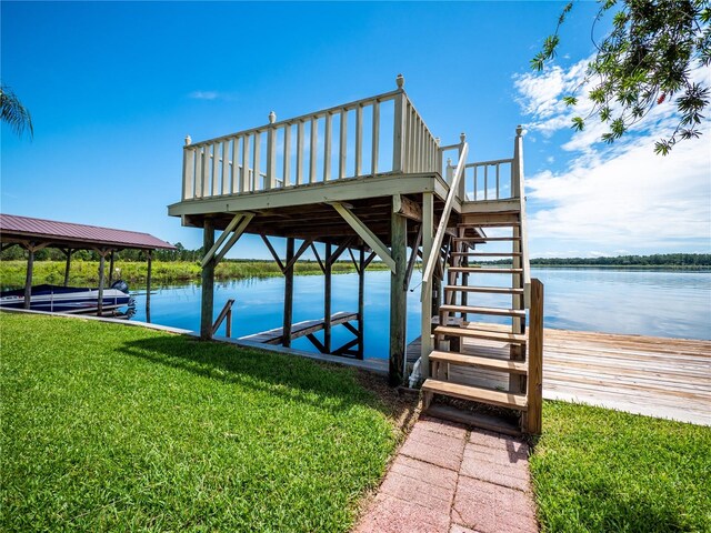 dock area with a water view and a lawn