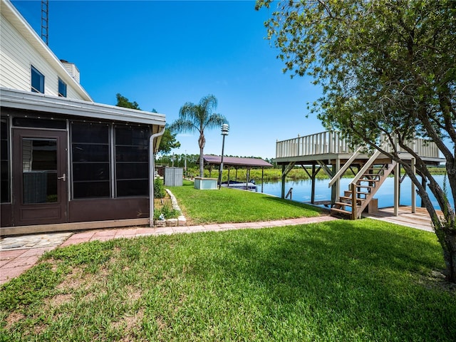 view of yard with a boat dock and a water view