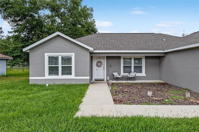 ranch-style home featuring a front yard