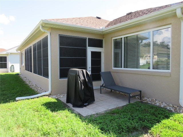 rear view of property with a sunroom and a yard