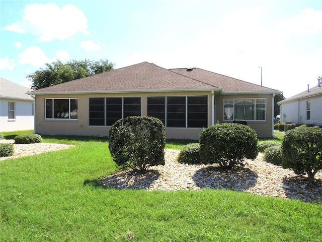 rear view of house featuring a yard