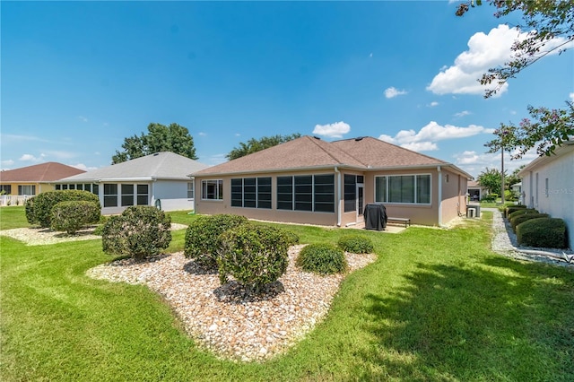 rear view of house with a lawn