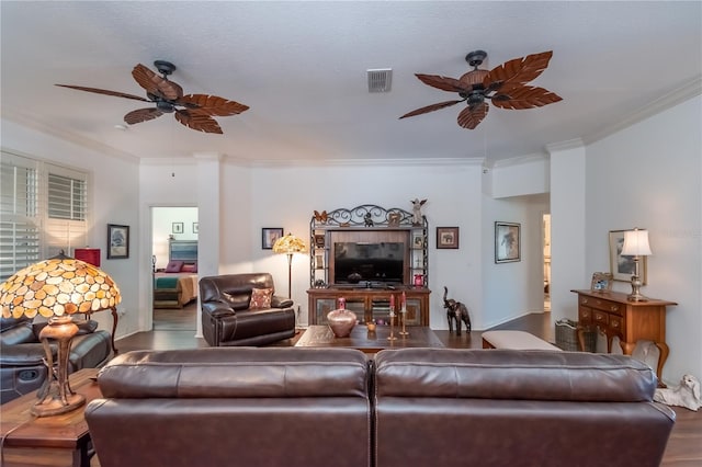 living room with ceiling fan, hardwood / wood-style floors, and ornamental molding