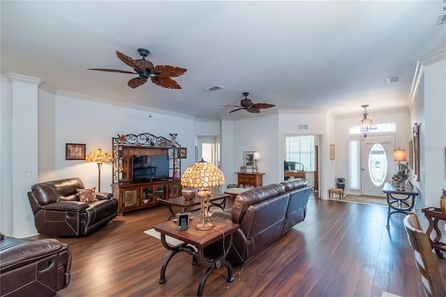 living room featuring hardwood / wood-style floors, ornamental molding, and ceiling fan