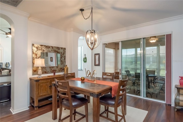 dining area featuring dark hardwood / wood-style flooring, ceiling fan with notable chandelier, and ornamental molding