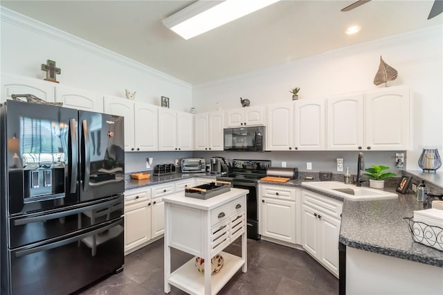 kitchen featuring sink, dark tile patterned flooring, black appliances, and a kitchen island