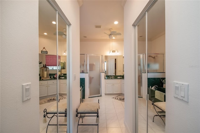 corridor with sink and light tile patterned floors