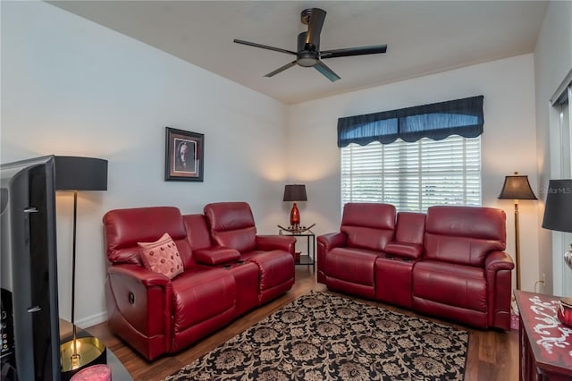 living room with ceiling fan and dark wood-type flooring