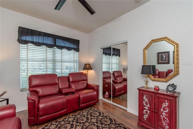 living room featuring dark hardwood / wood-style flooring, plenty of natural light, and ceiling fan