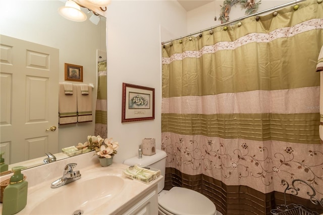 bathroom featuring toilet and vanity