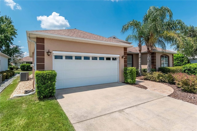 ranch-style house with central AC and a garage