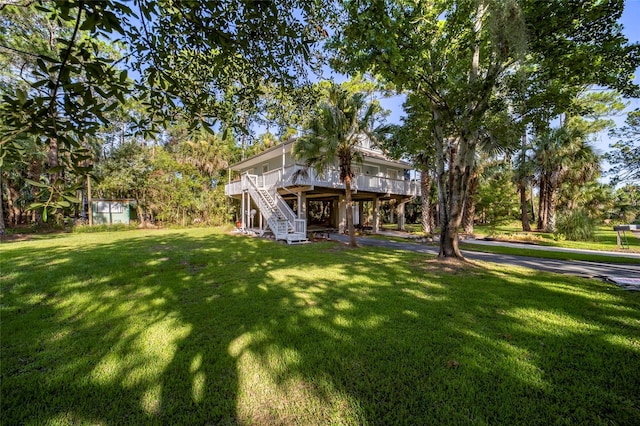 exterior space with a wooden deck and a front lawn