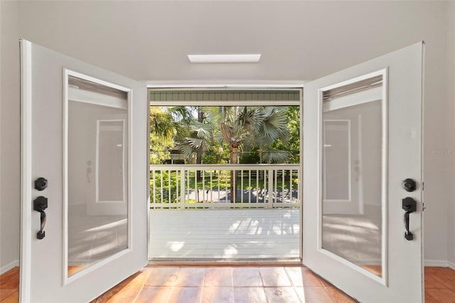 doorway to outside featuring light tile patterned floors