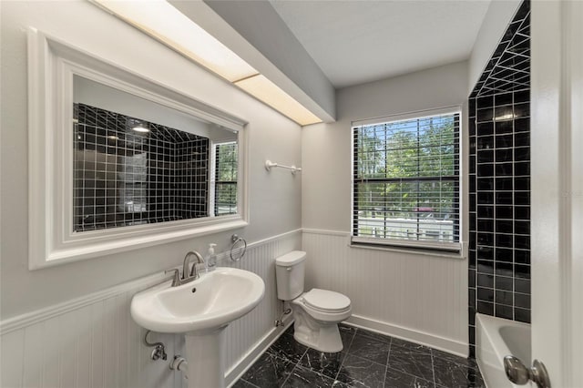 full bathroom with shower / bathtub combination, toilet, and sink