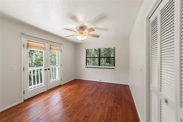 unfurnished bedroom with french doors, wood-type flooring, a textured ceiling, ceiling fan, and access to exterior