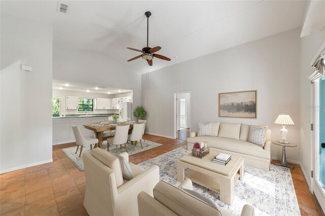 living room featuring high vaulted ceiling and ceiling fan