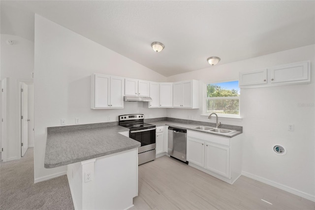 kitchen featuring appliances with stainless steel finishes, light carpet, white cabinets, and vaulted ceiling