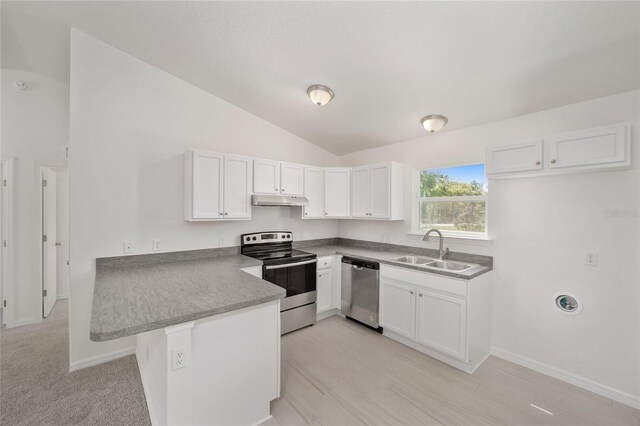 kitchen featuring light carpet, lofted ceiling, white cabinets, and stainless steel appliances