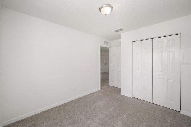 unfurnished bedroom featuring a closet and carpet