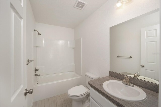 full bathroom featuring tile patterned floors, bathtub / shower combination, toilet, and vanity