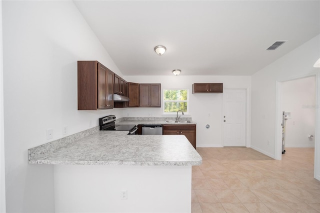 kitchen with lofted ceiling, light tile patterned floors, kitchen peninsula, appliances with stainless steel finishes, and sink