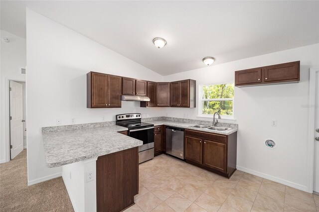 kitchen featuring light tile patterned floors, stainless steel appliances, sink, vaulted ceiling, and kitchen peninsula