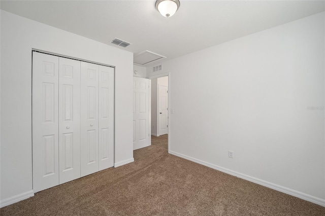 unfurnished bedroom with a closet and dark carpet