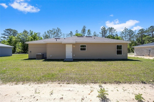 back of property with a lawn and cooling unit