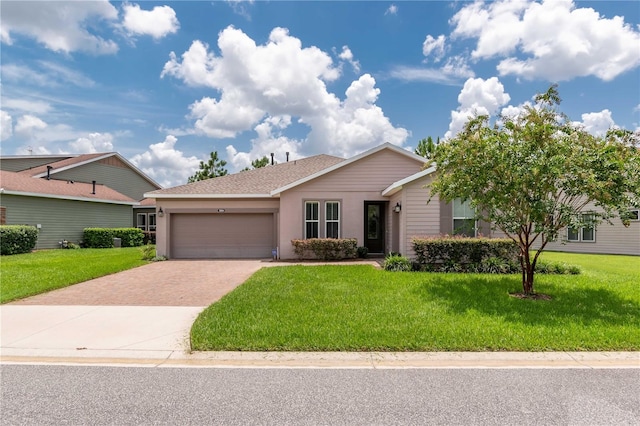 ranch-style house with a garage and a front lawn