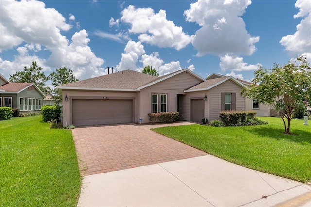 ranch-style house featuring a garage and a front lawn