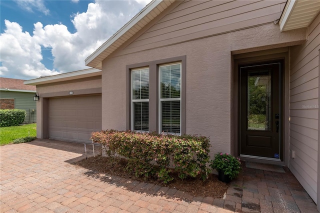 doorway to property with a garage